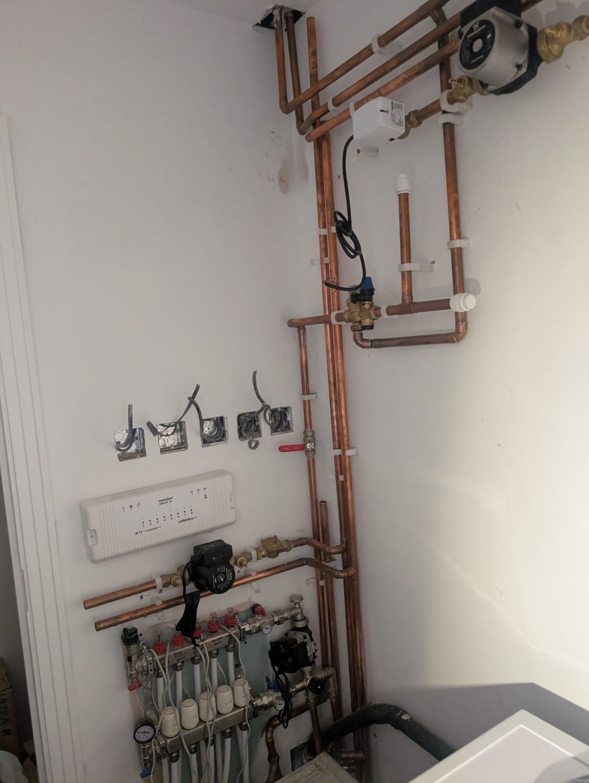Underfloor heating manifold and copper pipework in a Greenwich home